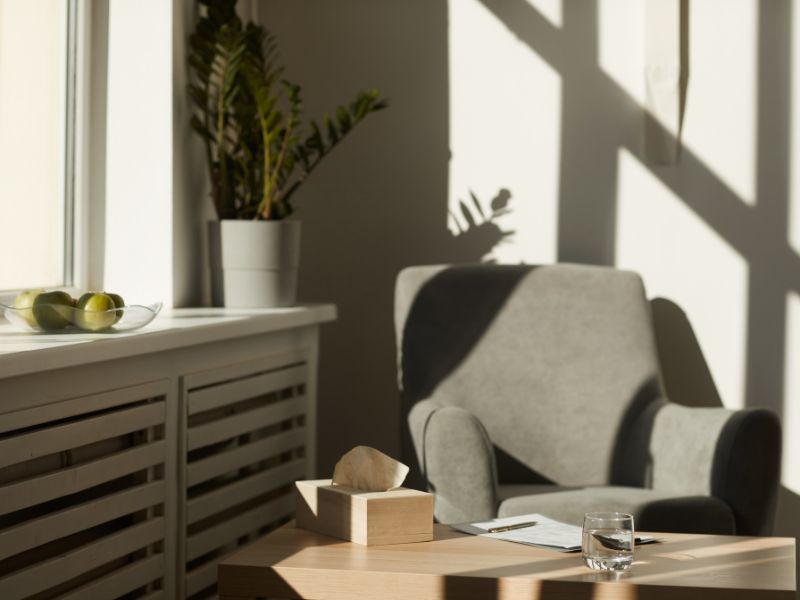 Warm and welcoming therapy office with natural light, comfortable seating, and calming wellness-inspired decor.