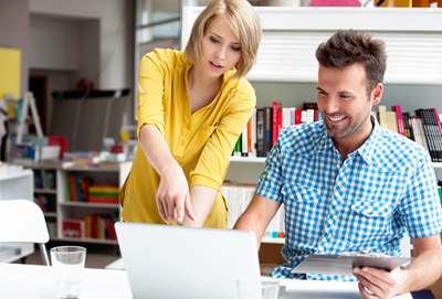 Two counseling professionals collaborating during a clinical supervision meeting in an office setting.